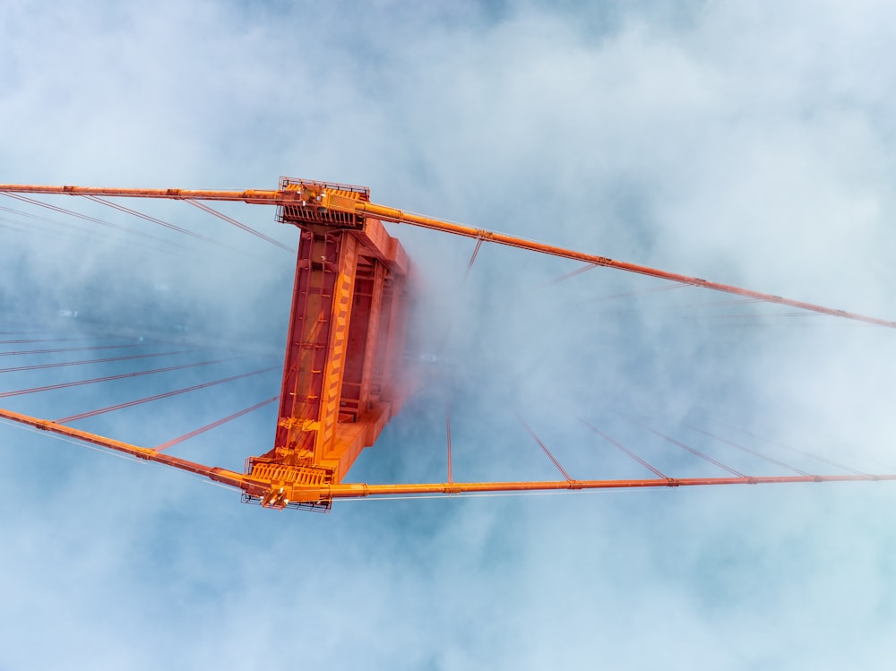 a view of the top of a bridge in the clouds