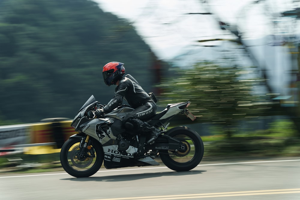 a man riding a motorcycle down a street