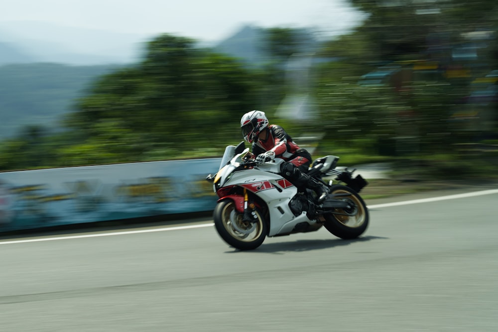 a man riding a motorcycle down a curvy road