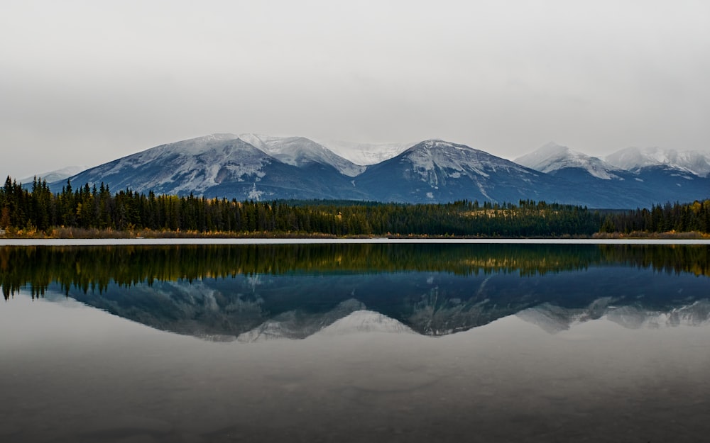 a large body of water with mountains in the background