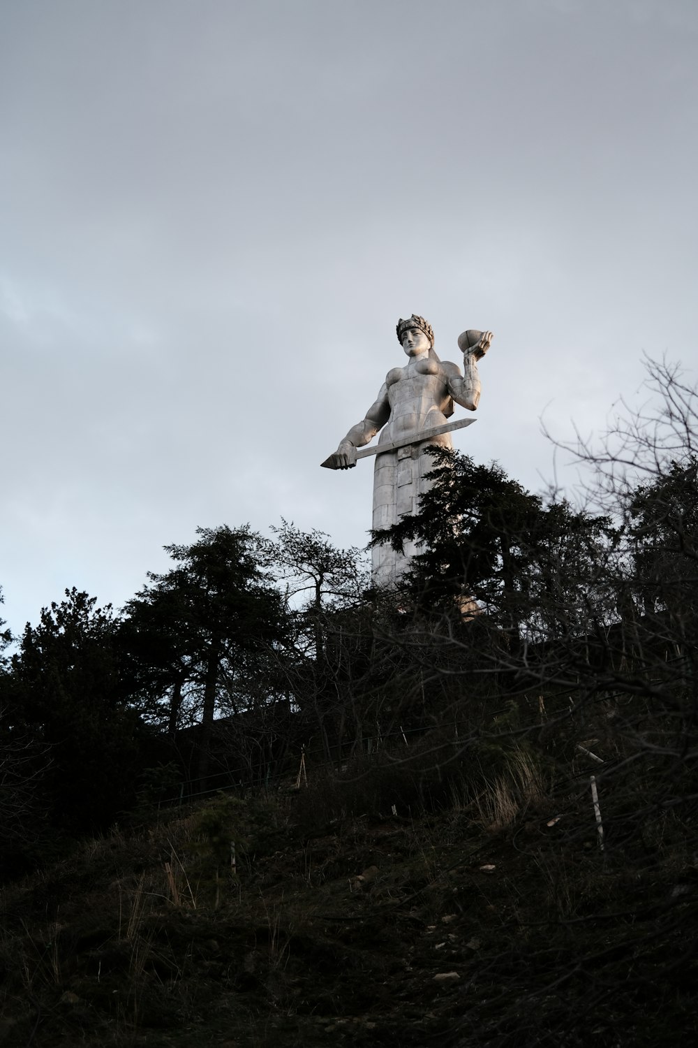 a statue of a man on top of a hill