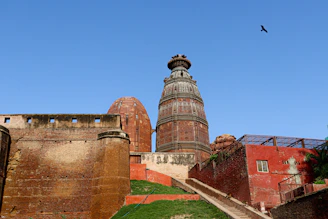 an old building with a bird flying over it