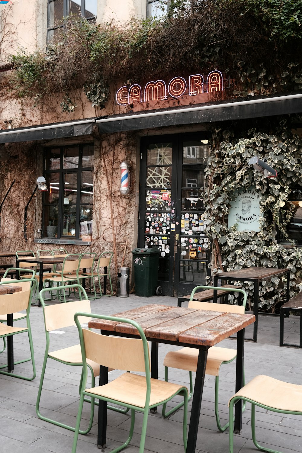 a restaurant with tables and chairs outside of it