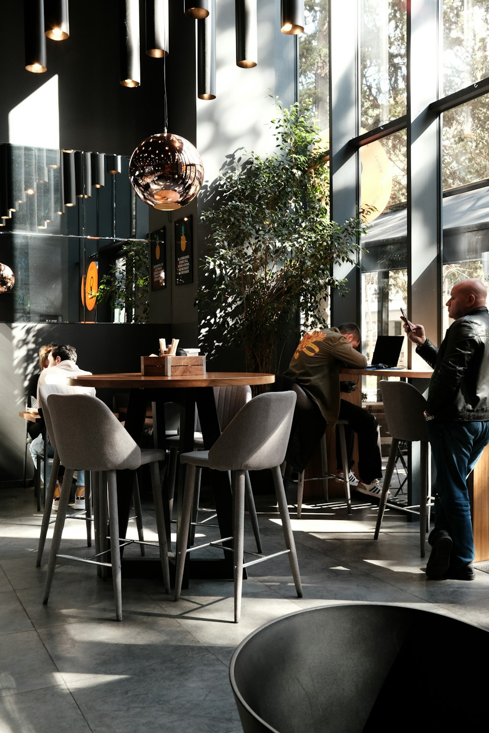 a person sitting at a table with a laptop