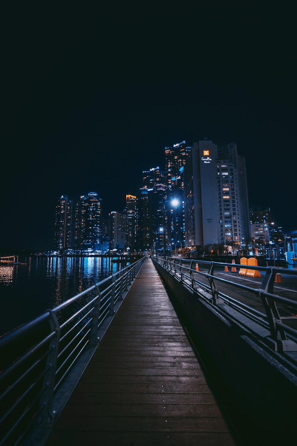 a long pier with a city in the background