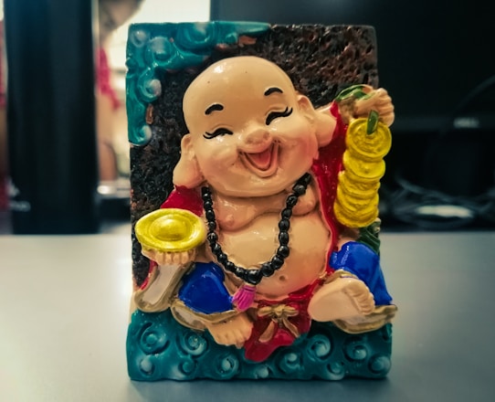 A shiny golden coin character with big eyes surrounded by playful noodles and sparkling nuggets.