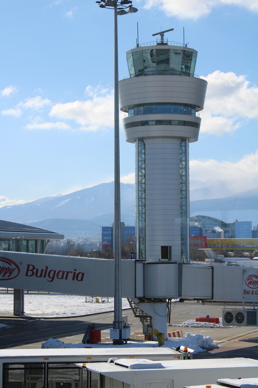 an airport with a control tower in the background