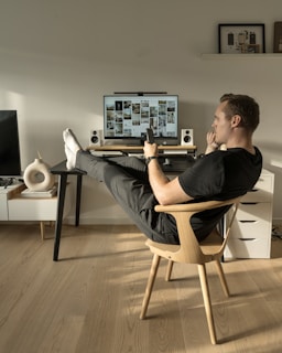 a man sitting in a chair in front of a computer