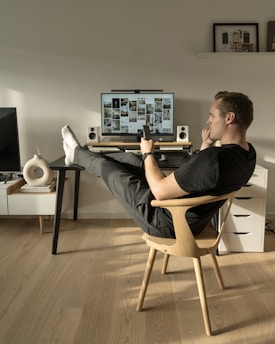 a man sitting in a chair in front of a computer