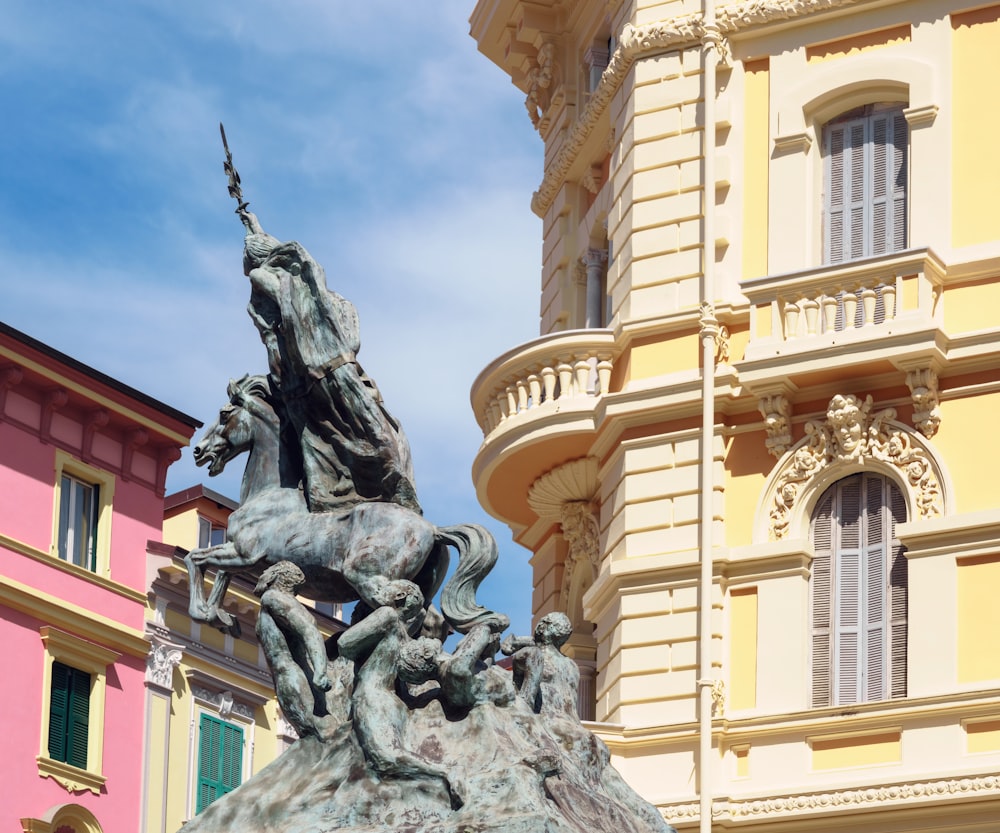 a statue of a man on a horse in front of a building