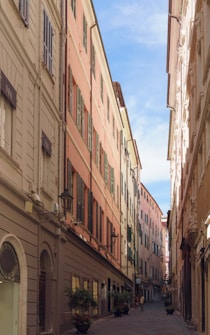 a narrow city street lined with tall buildings