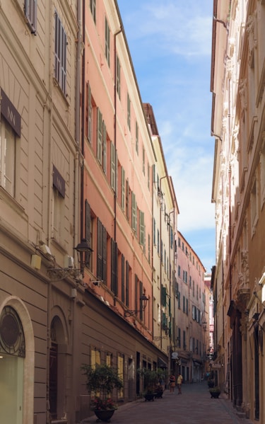 a narrow city street lined with tall buildings