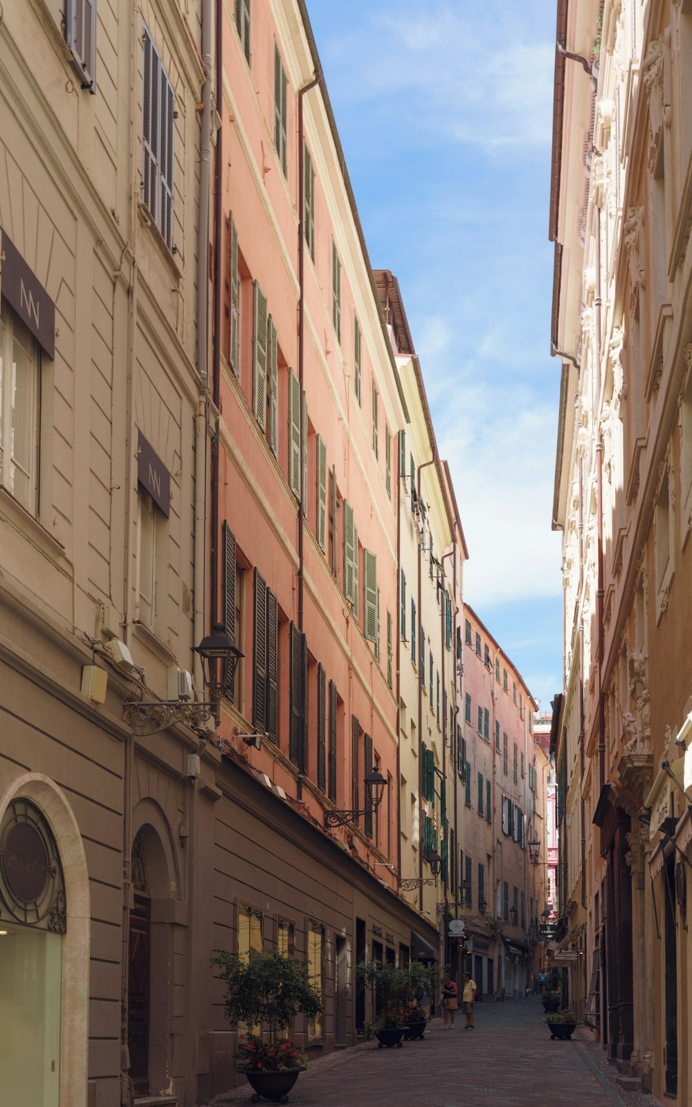 a narrow city street lined with tall buildings