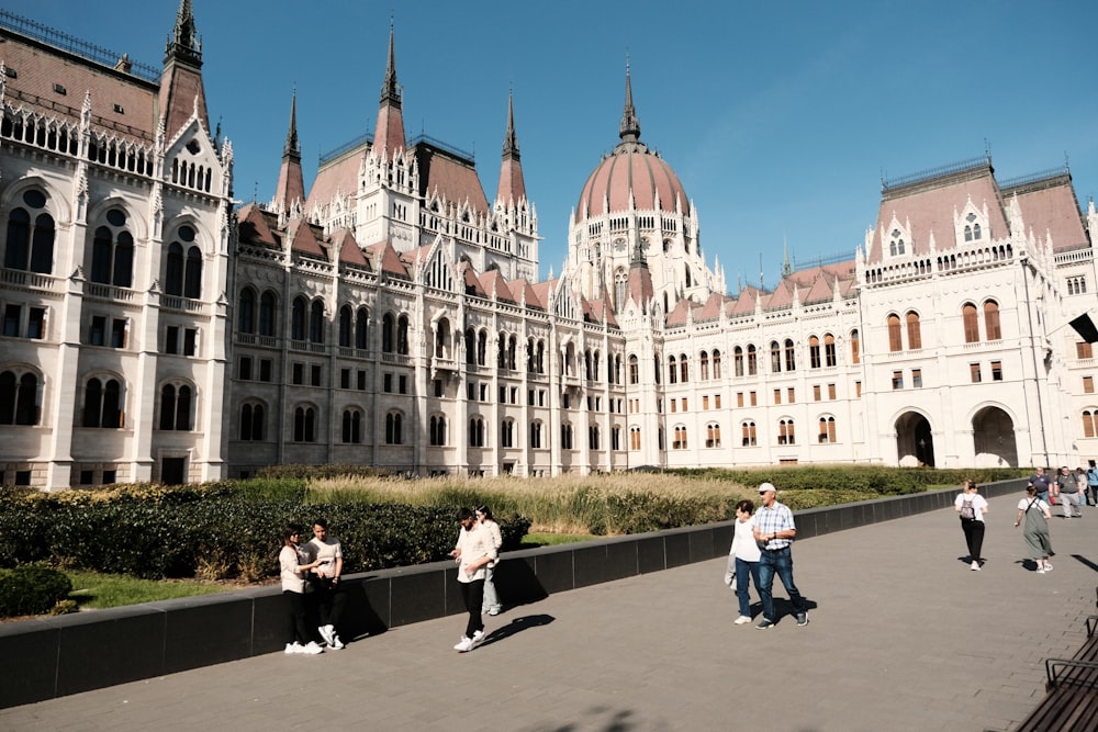 a group of people walking around a large building