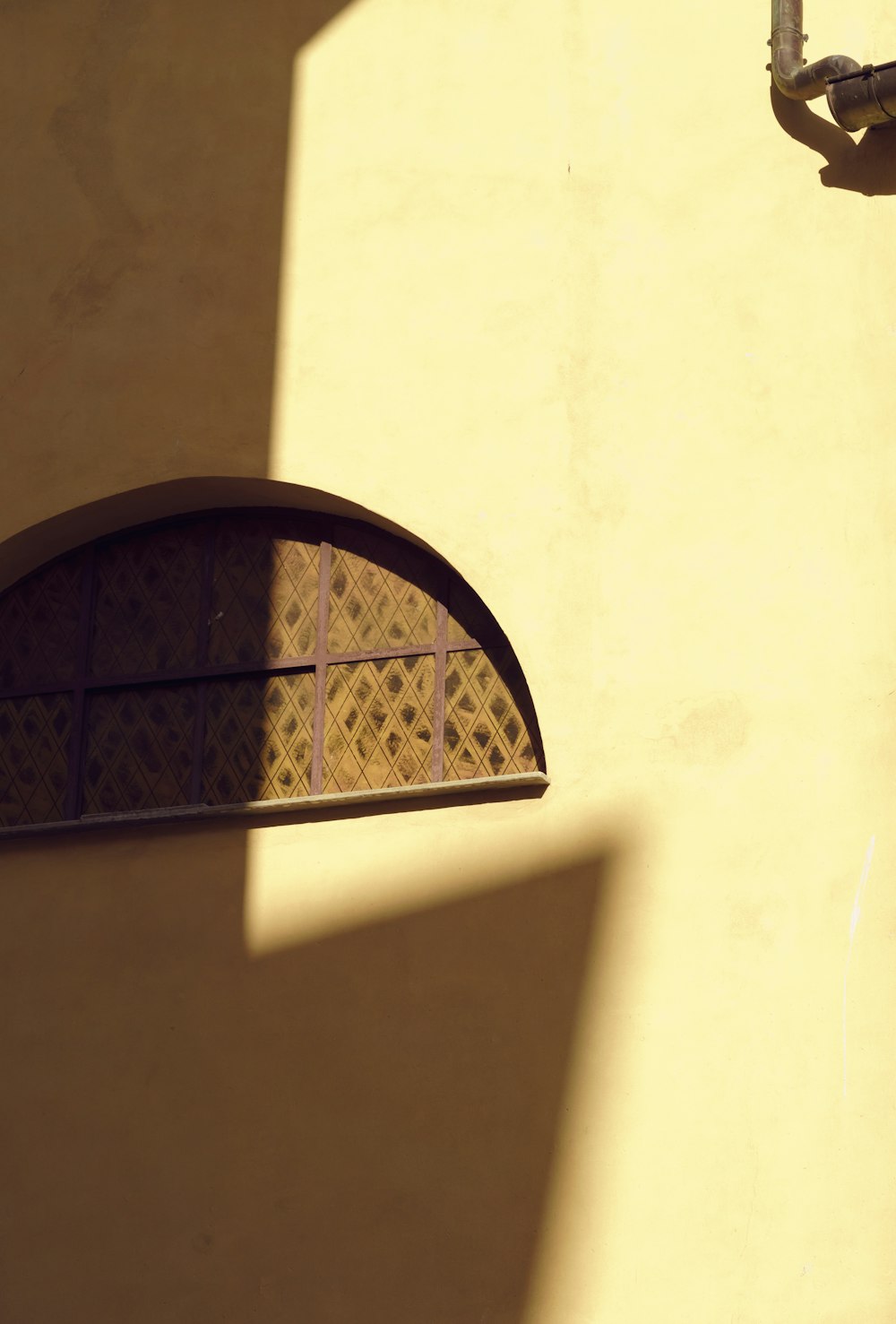 the shadow of a street light on a building