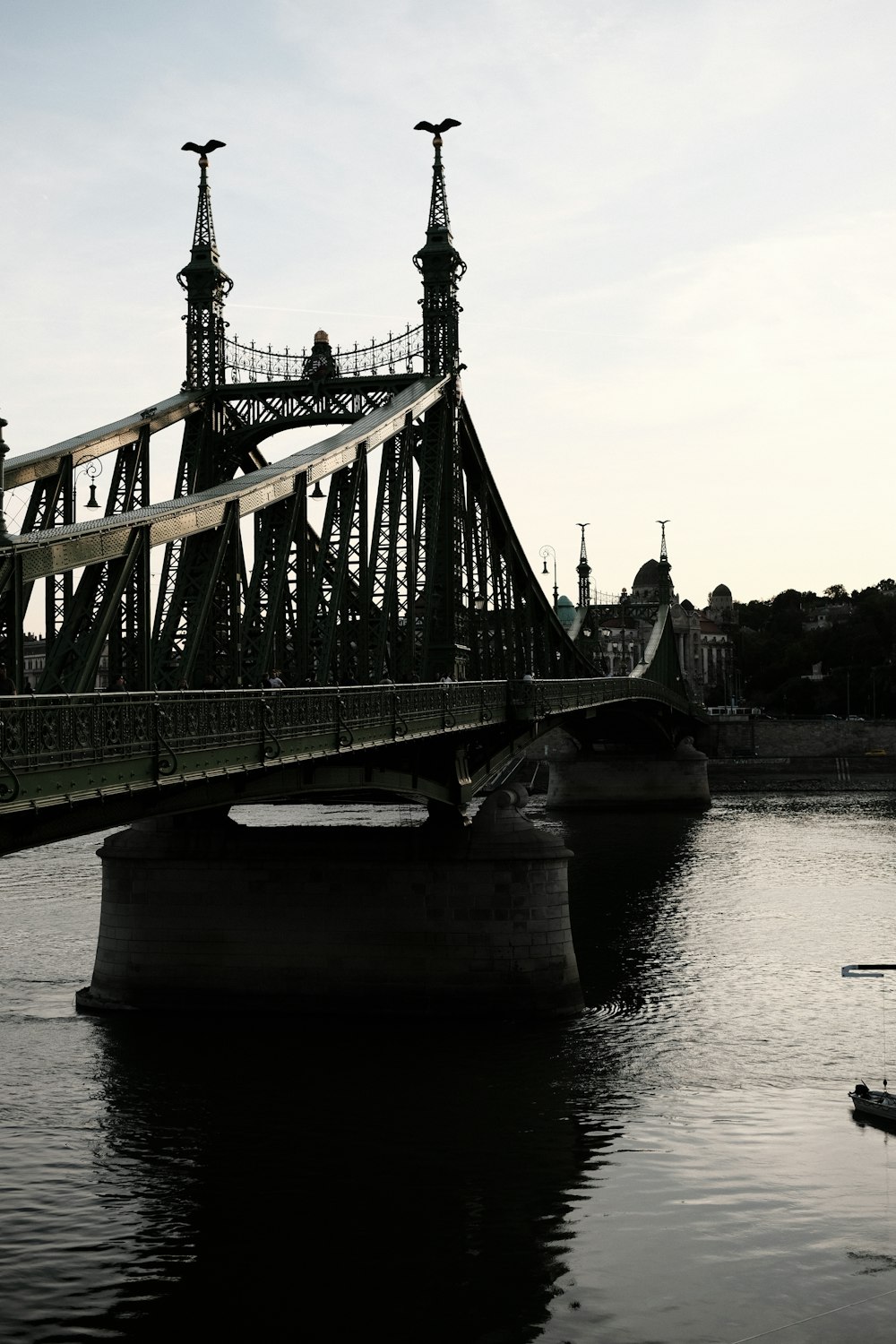 a bridge over a body of water with a boat on it