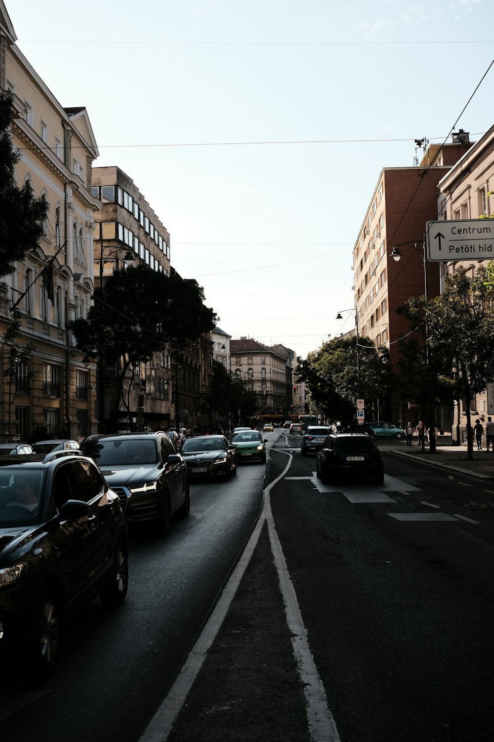 a street filled with lots of traffic next to tall buildings