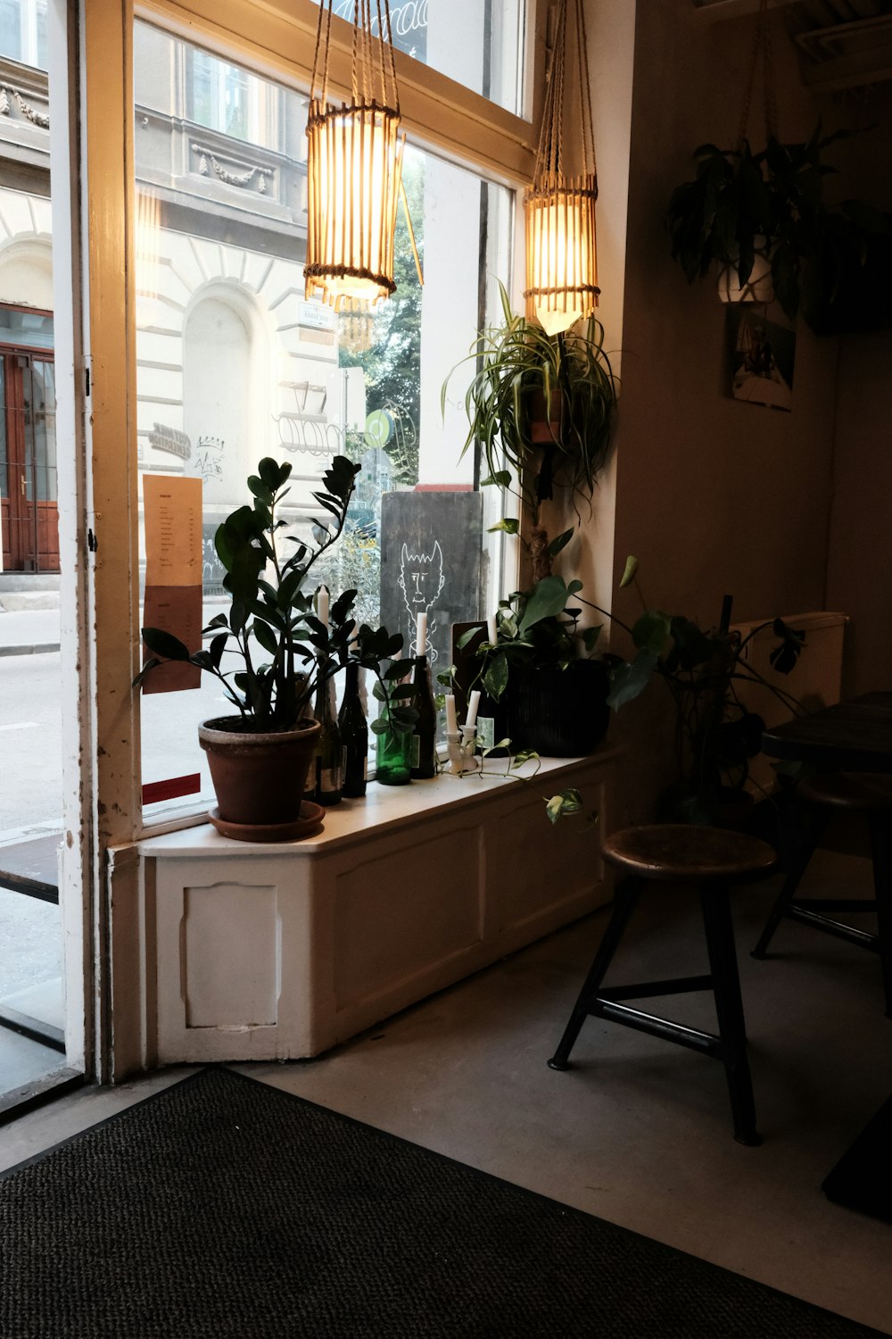 a window sill filled with potted plants in front of a window