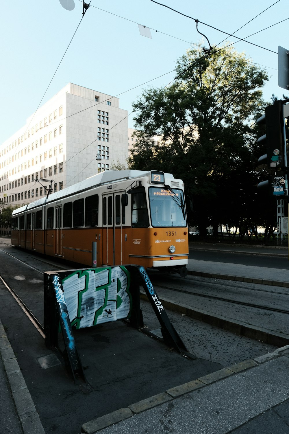 an orange and white train traveling down train tracks