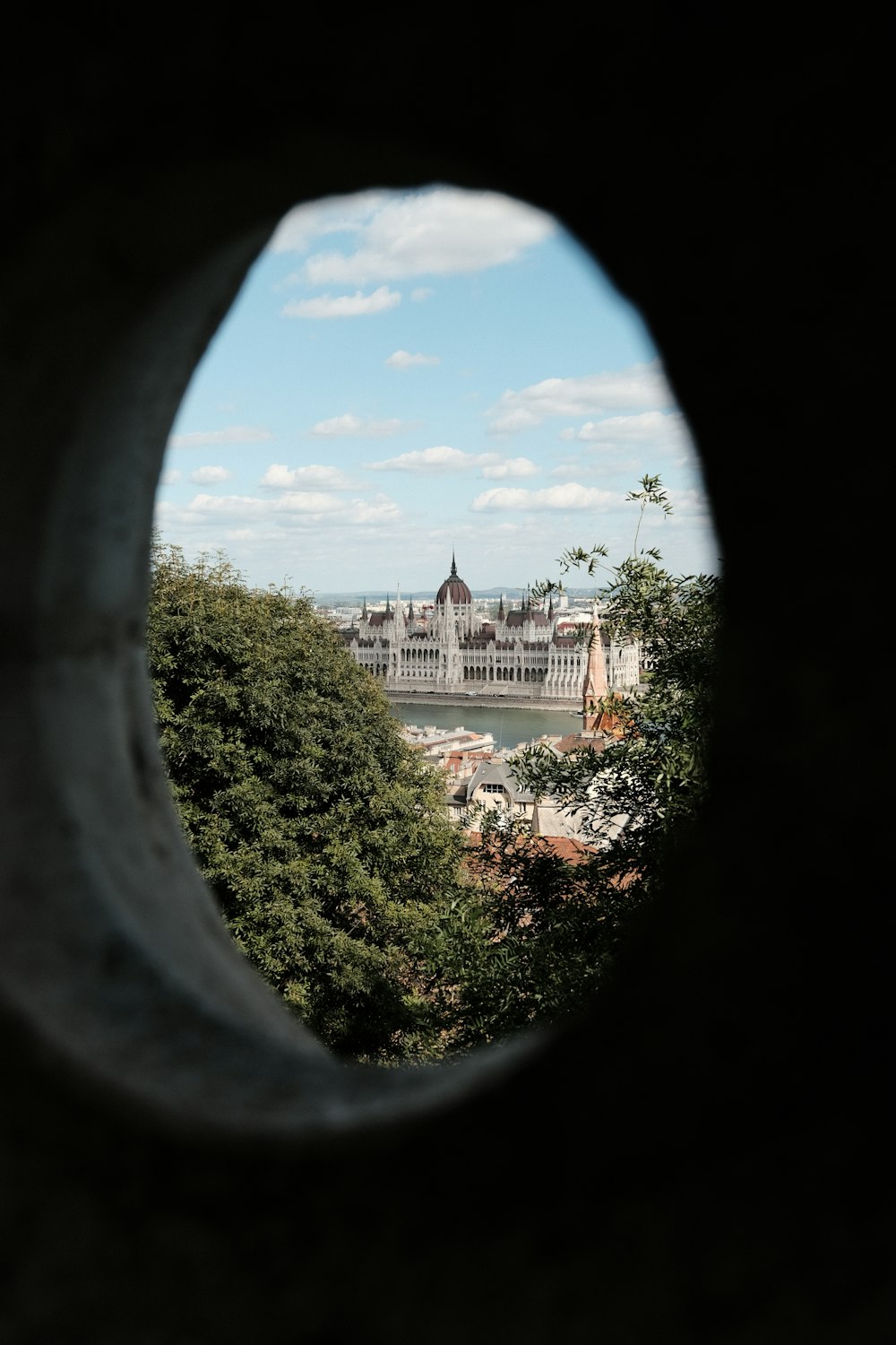 a view of a castle through a hole in a wall