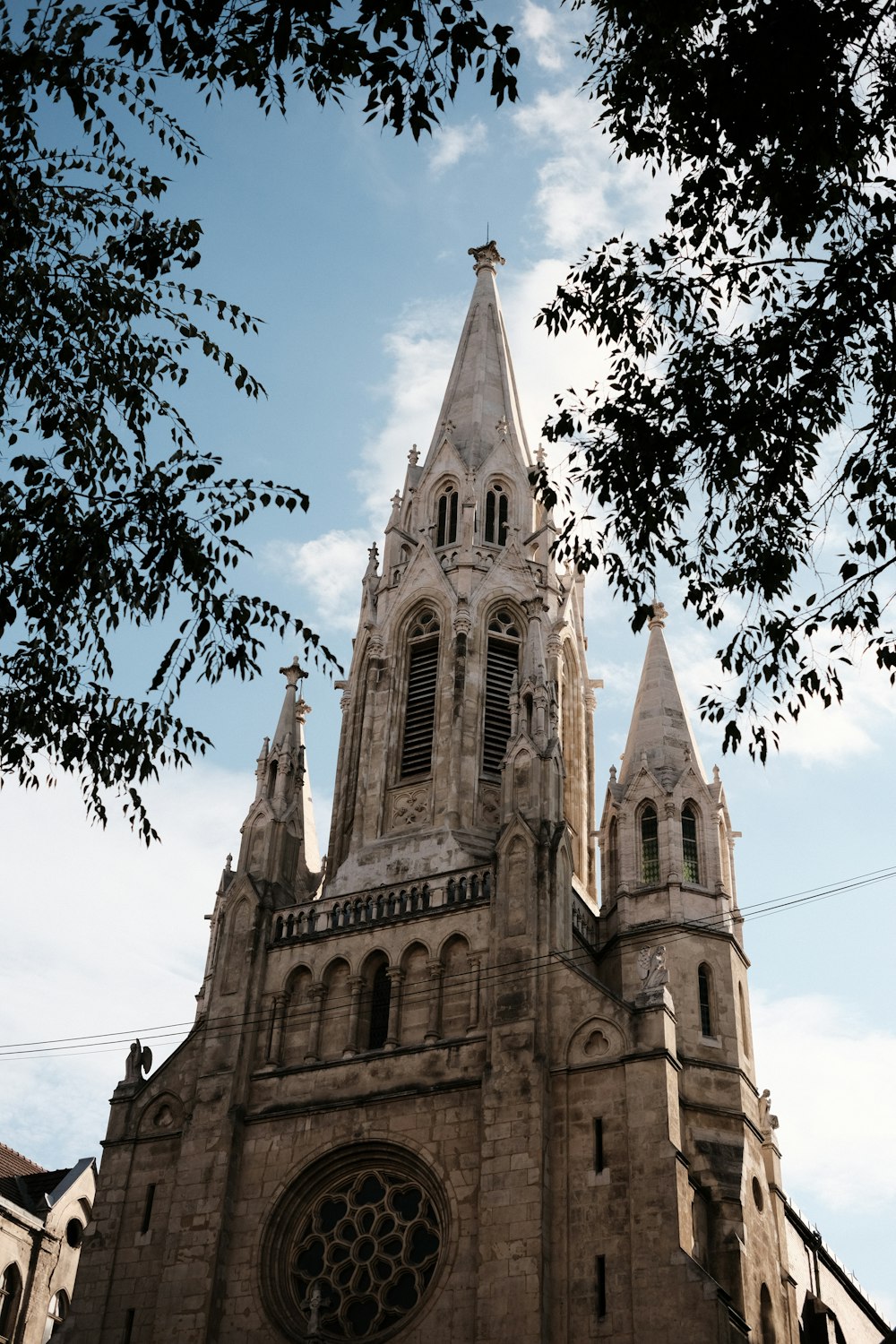 a tall cathedral with a clock on it's side