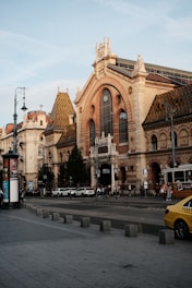 a yellow taxi is parked in front of a large building