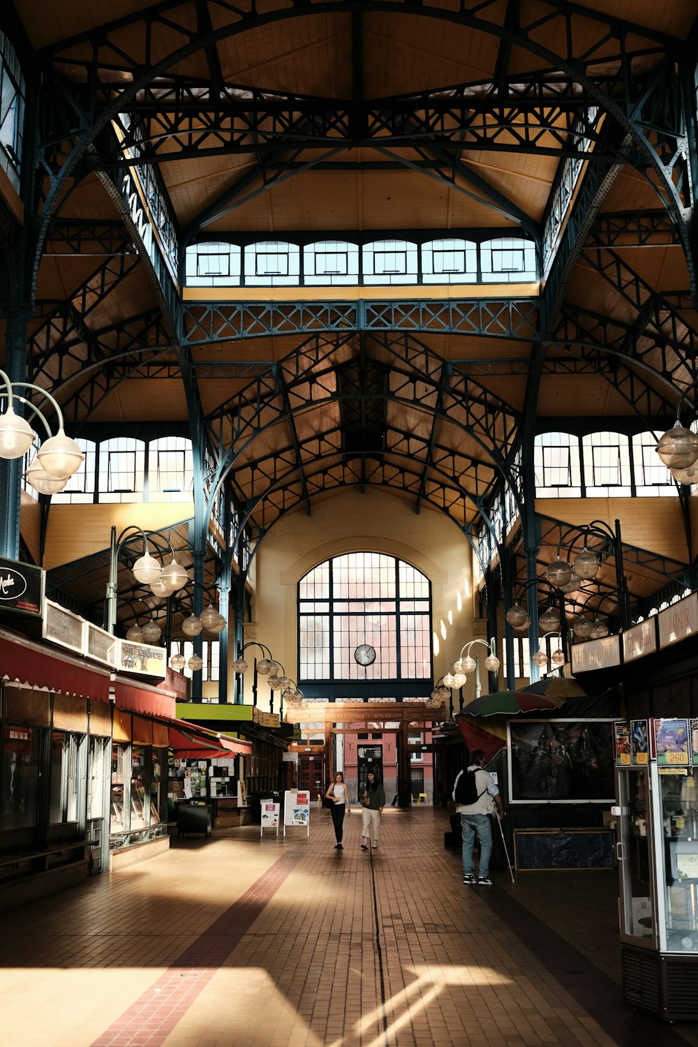 the inside of a train station with people walking around