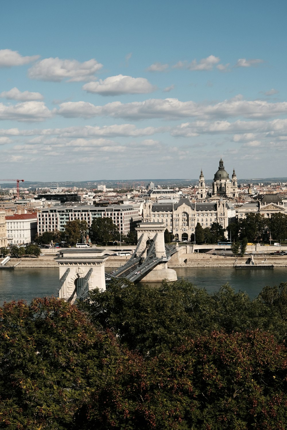 a view of a city and a river from a hill