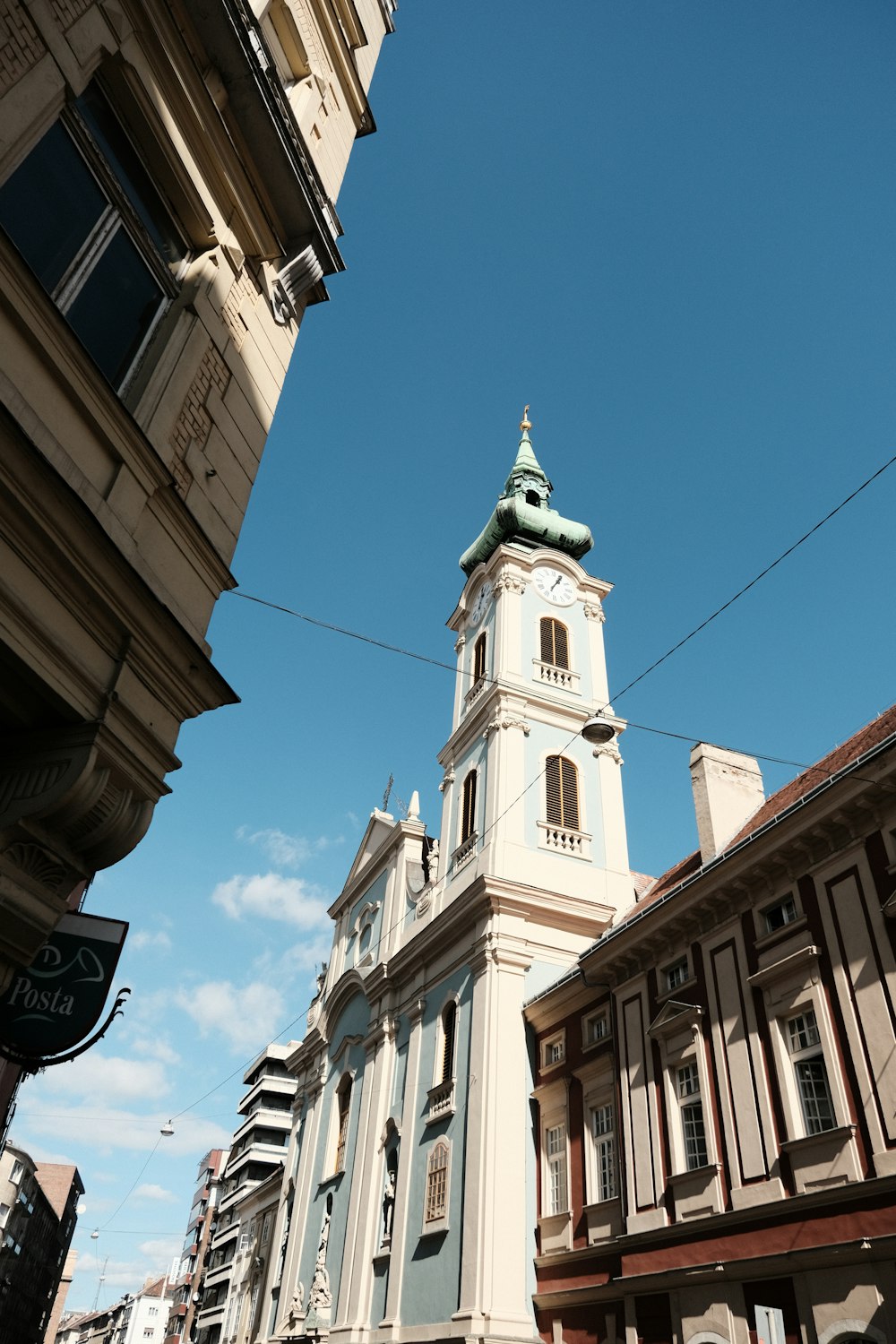 a tall white clock tower towering over a city