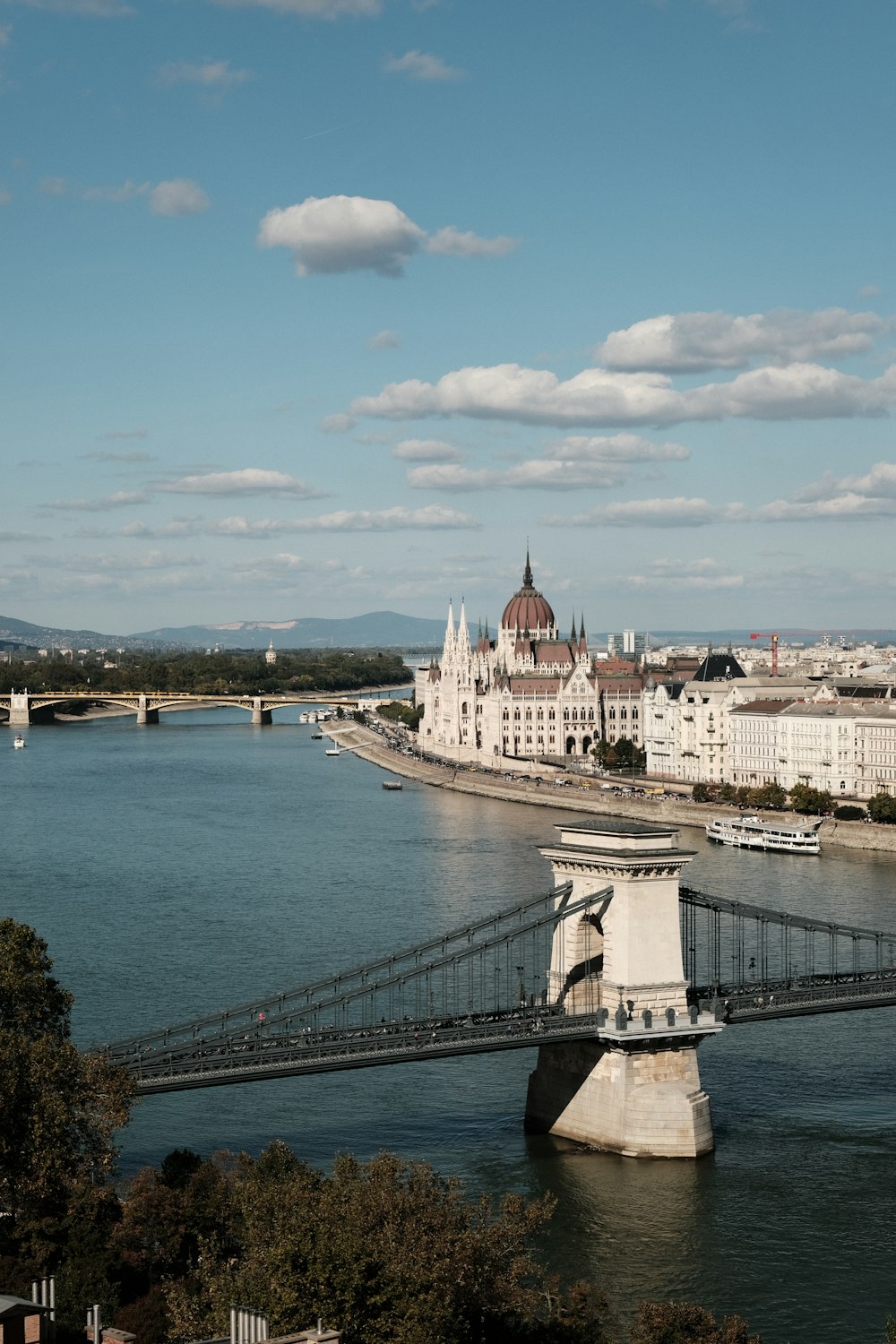 a bridge over a body of water with buildings in the background