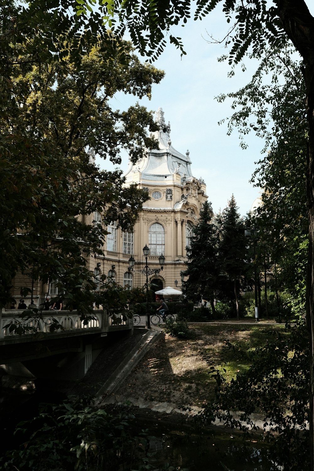 a large building sitting next to a lush green forest