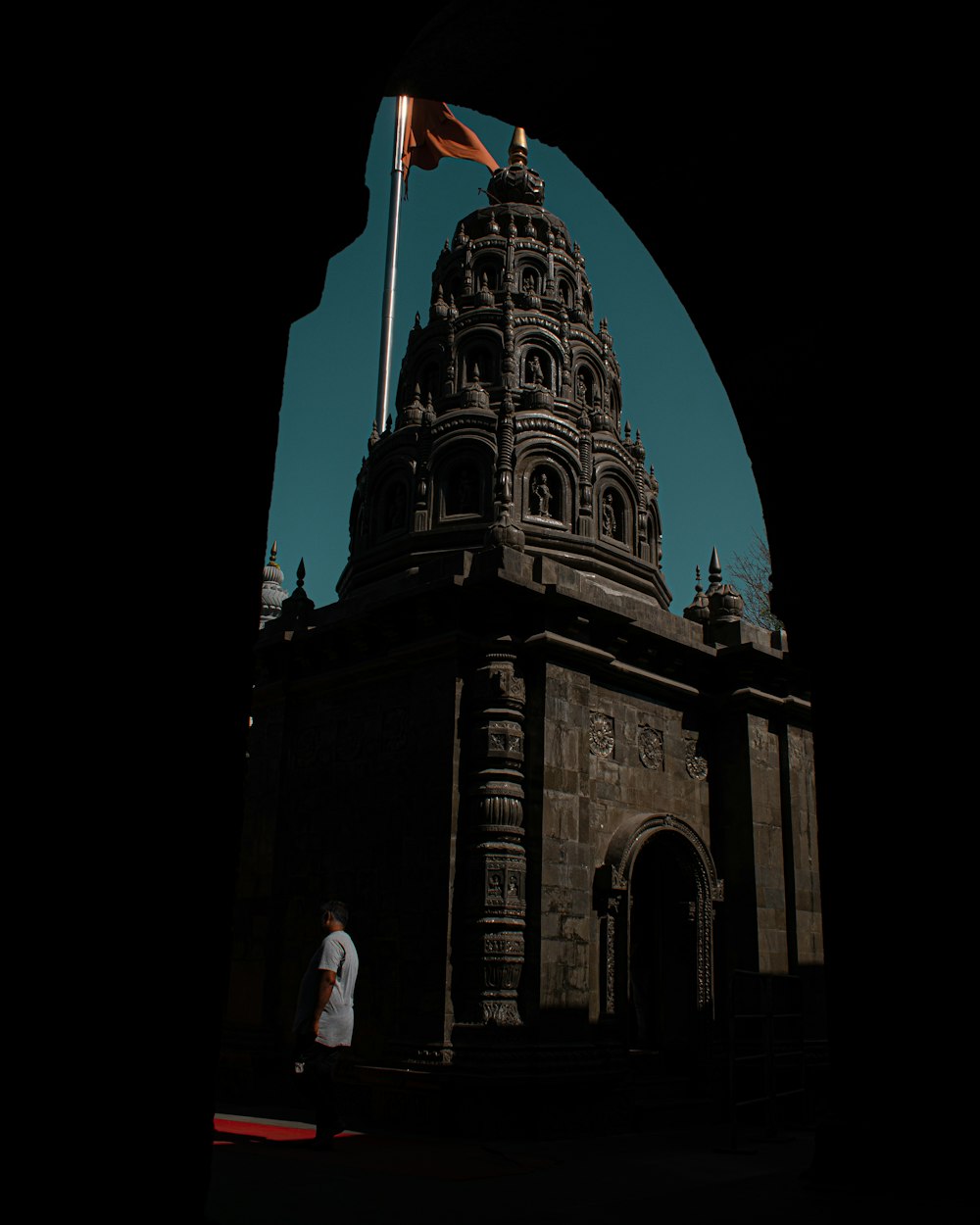 a tall tower with a flag on top of it