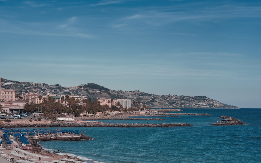 a view of a beach with a hill in the background