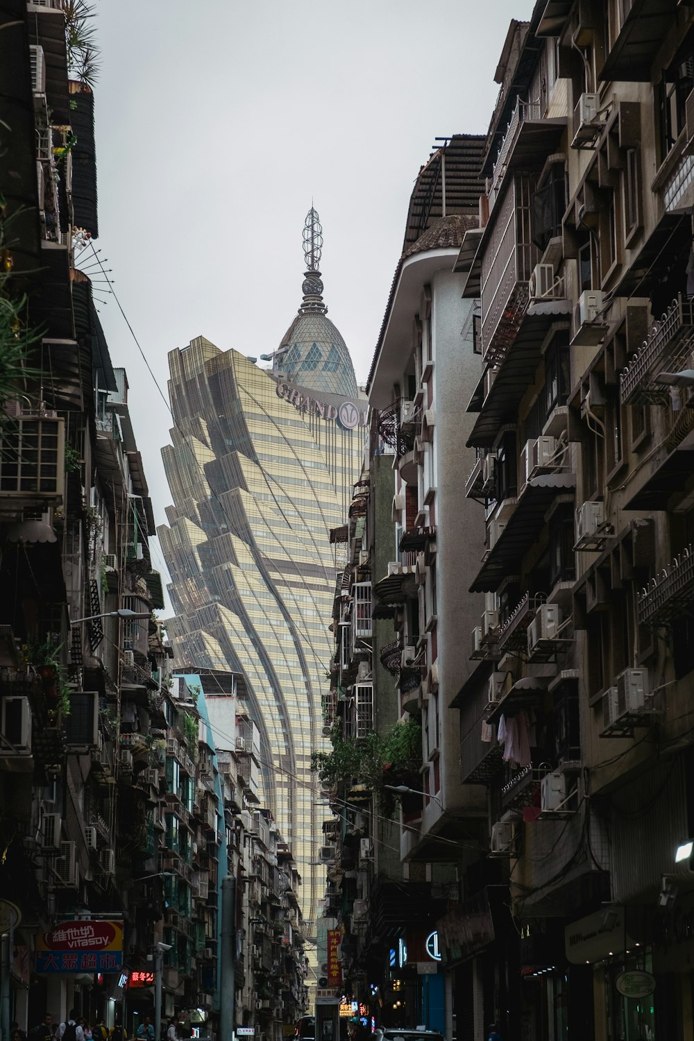 a very tall building towering over a city filled with tall buildings