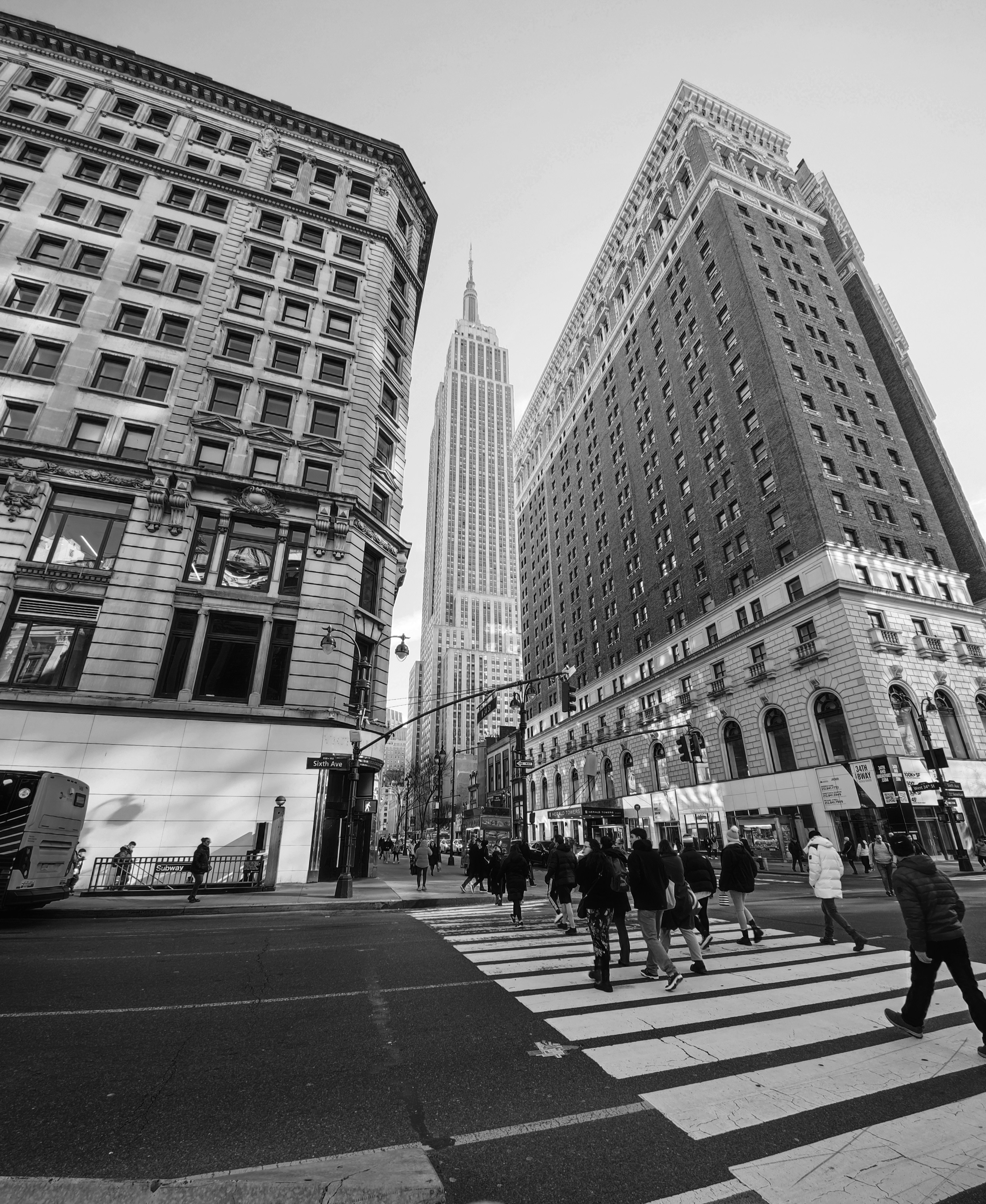 a group of people walking across a cross walk
