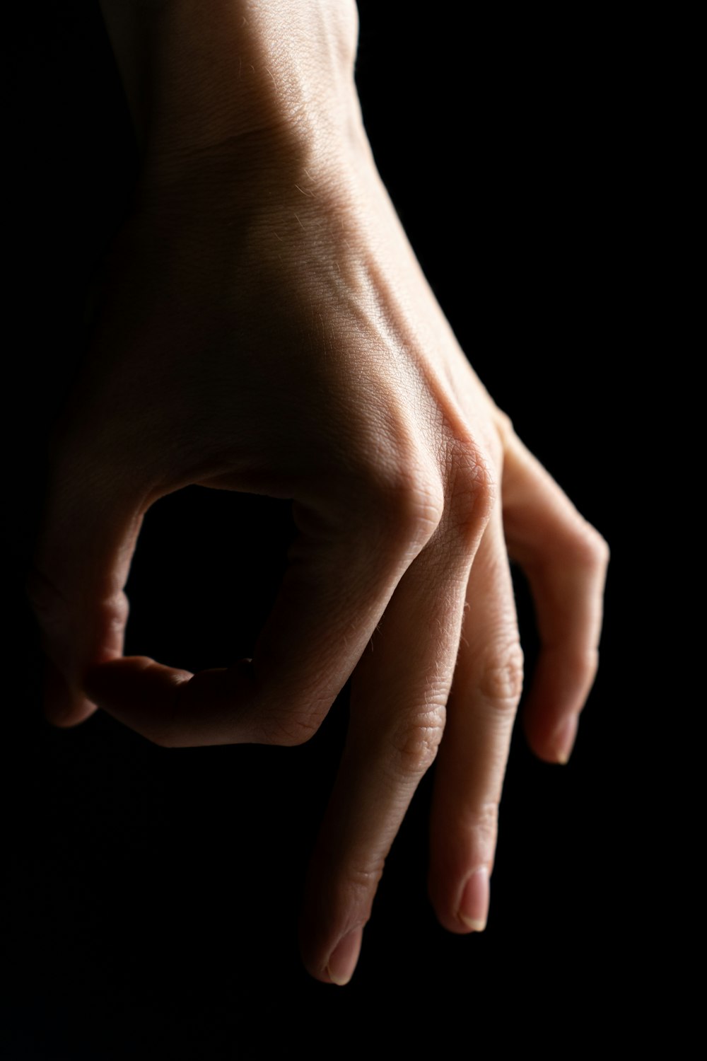 a person's hand reaching out towards the camera
