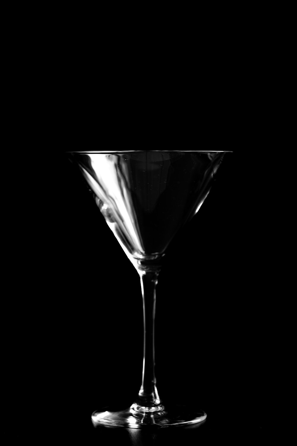 a black and white photo of a martini glass