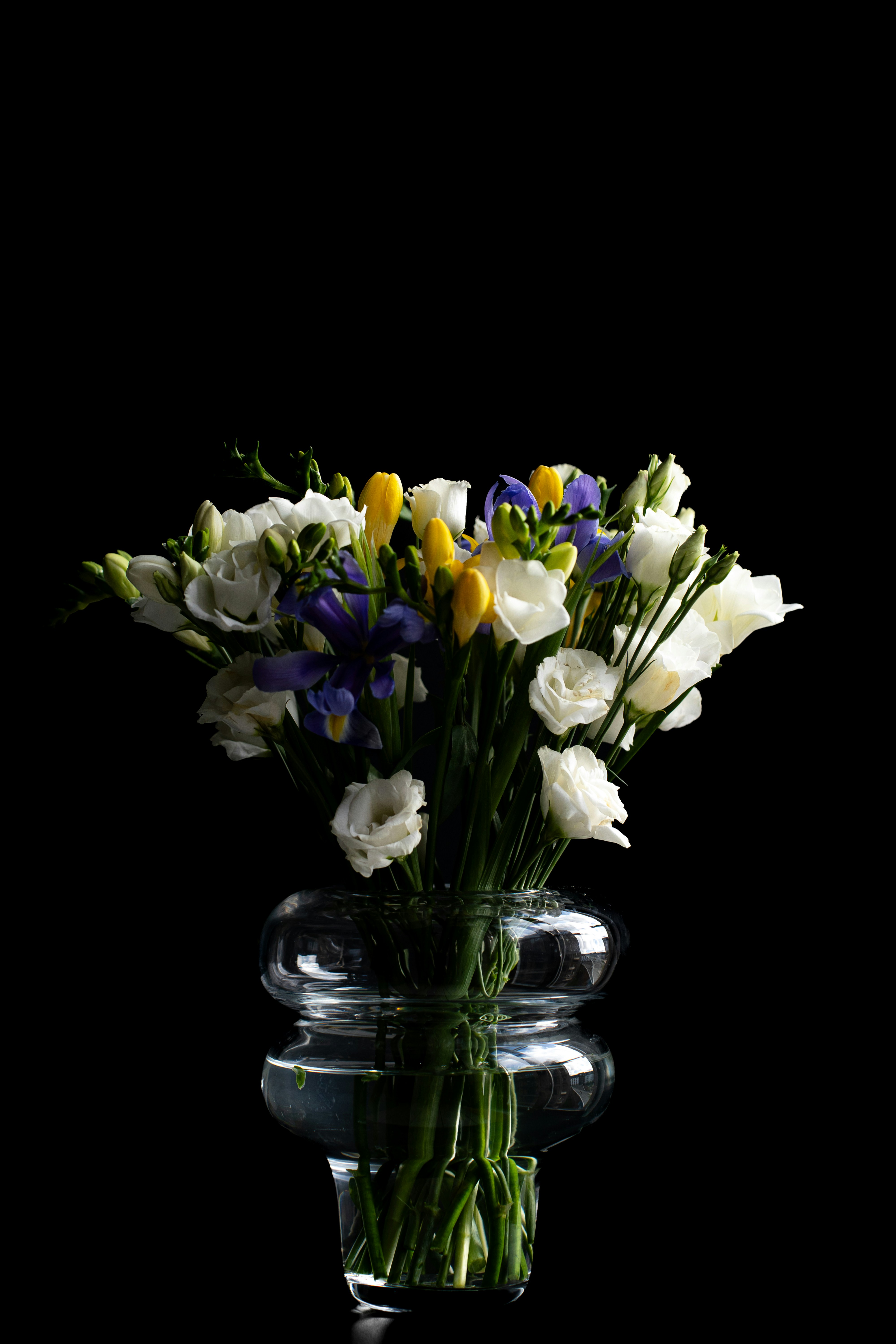 a vase filled with white and blue flowers