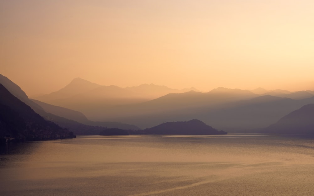 a body of water with mountains in the background