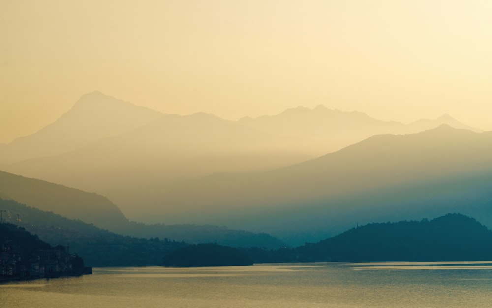 a body of water with mountains in the background