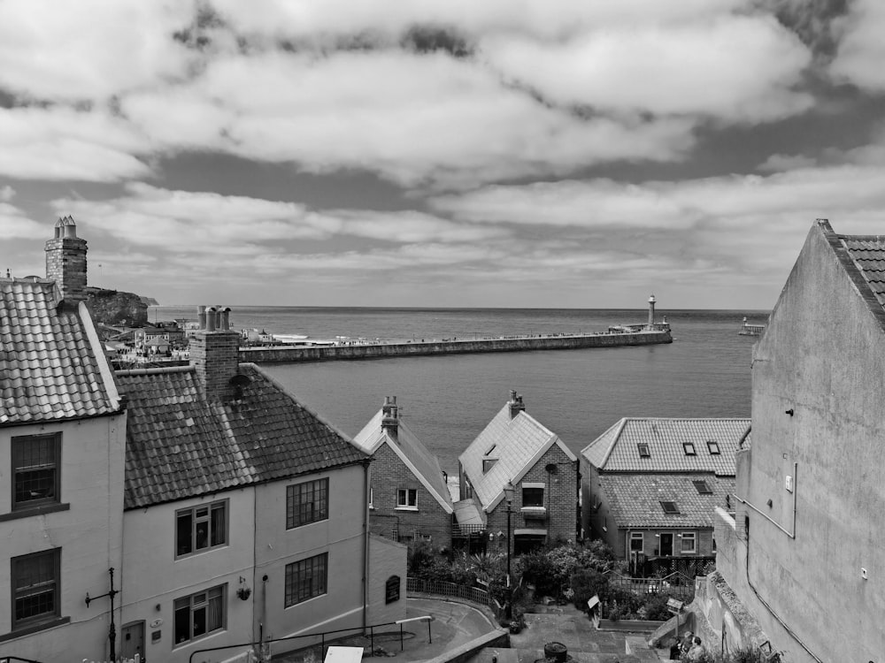 a black and white photo of some buildings and a body of water