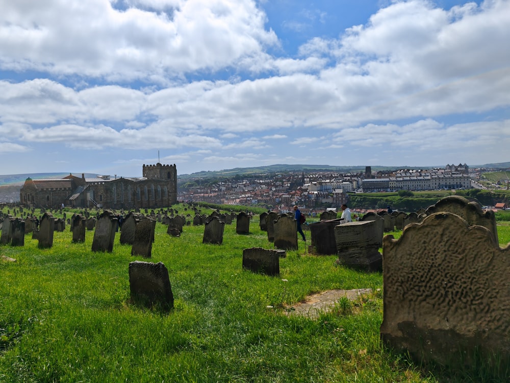 a cemetery with a view of a city in the distance