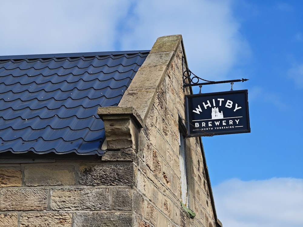 a sign hanging from the side of a building