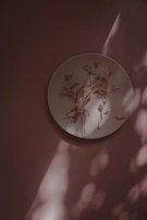 A set of stacked plates in soft pastel hues, glowing softly in natural light.