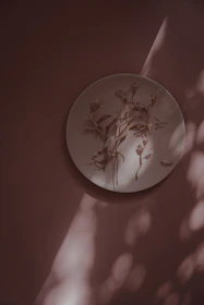 Stacked pastel-colored plates glowing softly under warm lighting, inviting slow moments.