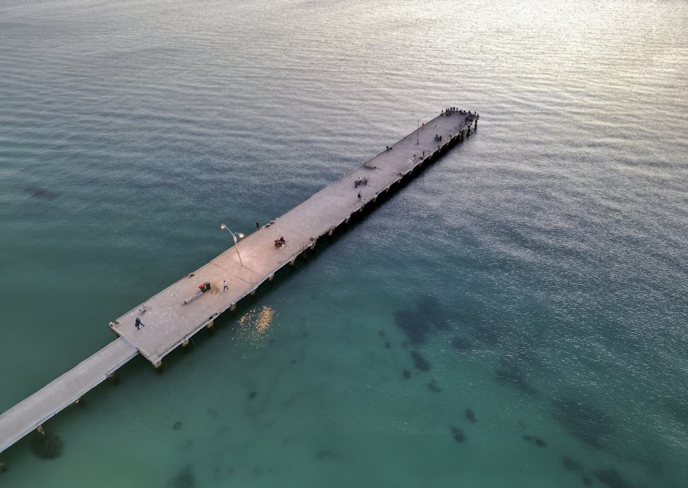 an aerial view of a pier in the ocean