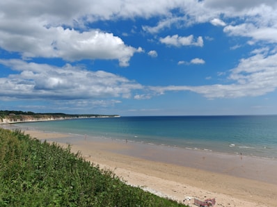 a view of a beach with a few people in the water