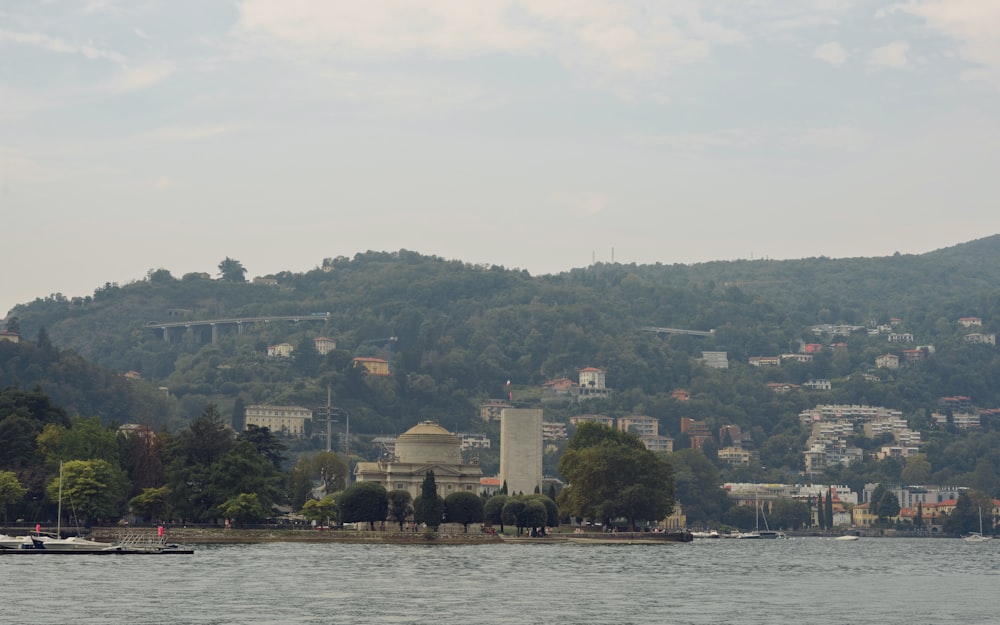 a body of water with a hill in the background