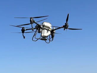 a black and white remote controlled flying in the sky