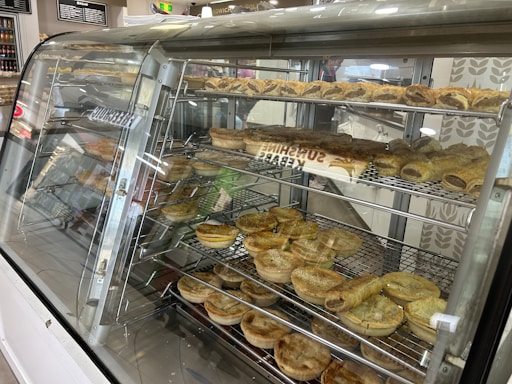 A modern and elegant bakery display showcasing freshly baked pies and pastries with golden crusts.
